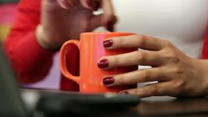 stock-footage-young-woman-fills-sugar-in-a-cup-of-hot-drink-and-stirring-by-its-teaspoon-in-a-office.jpg